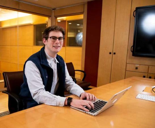 Graduate student working on a laptop.