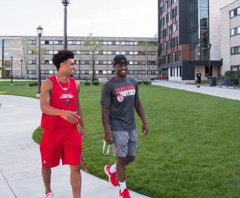 Students chat as they walk around campus.